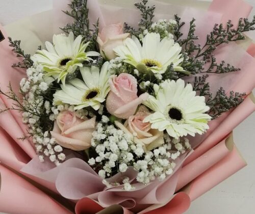 champagne roses in a hand bouquet