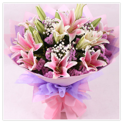 Pink lilies in a hand bouquet