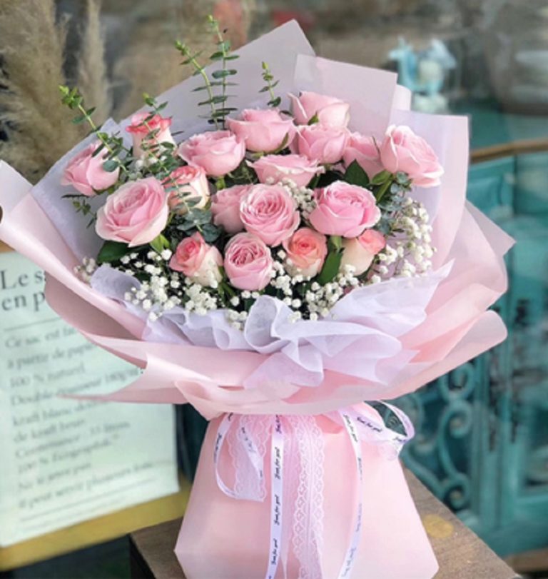 Pink rose bouquet in hand bouquet by Blooming Florist