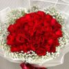 red roses in a hand bouquet