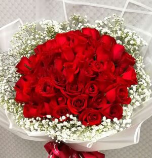 red roses in a hand bouquet