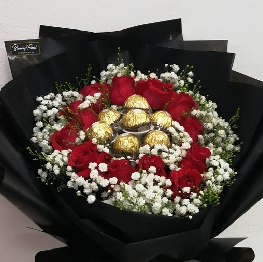 red roses and ferrero rocher in a hand bouquet