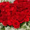 heart shaped arrangement of red roses in basket