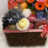 basket of mixed flowers & fruits with boxes of chocolate