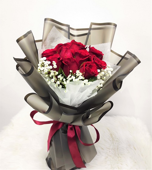 classic red roses in a hand bouquet with black wrapping