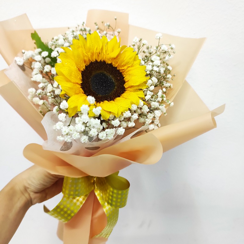 Sunflower in a hand bouquet