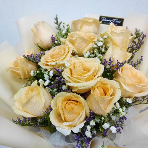 champagne roses in a hand bouquet