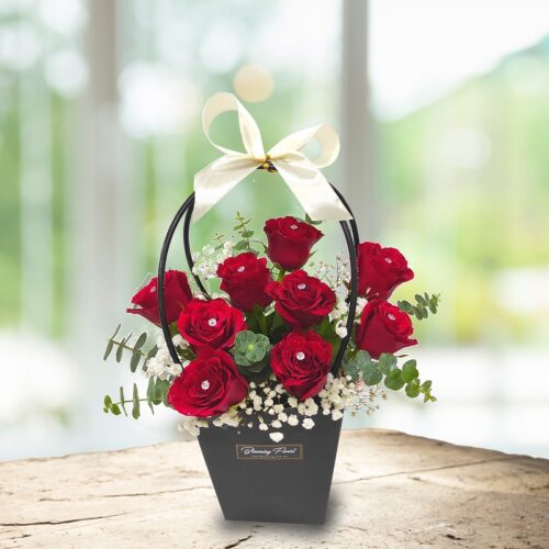 stunning arrangement of classic red roses with diamond pin