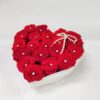 red roses in a see-through heartshape acrylic box