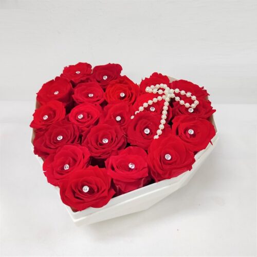 red roses in a see-through heartshape acrylic box