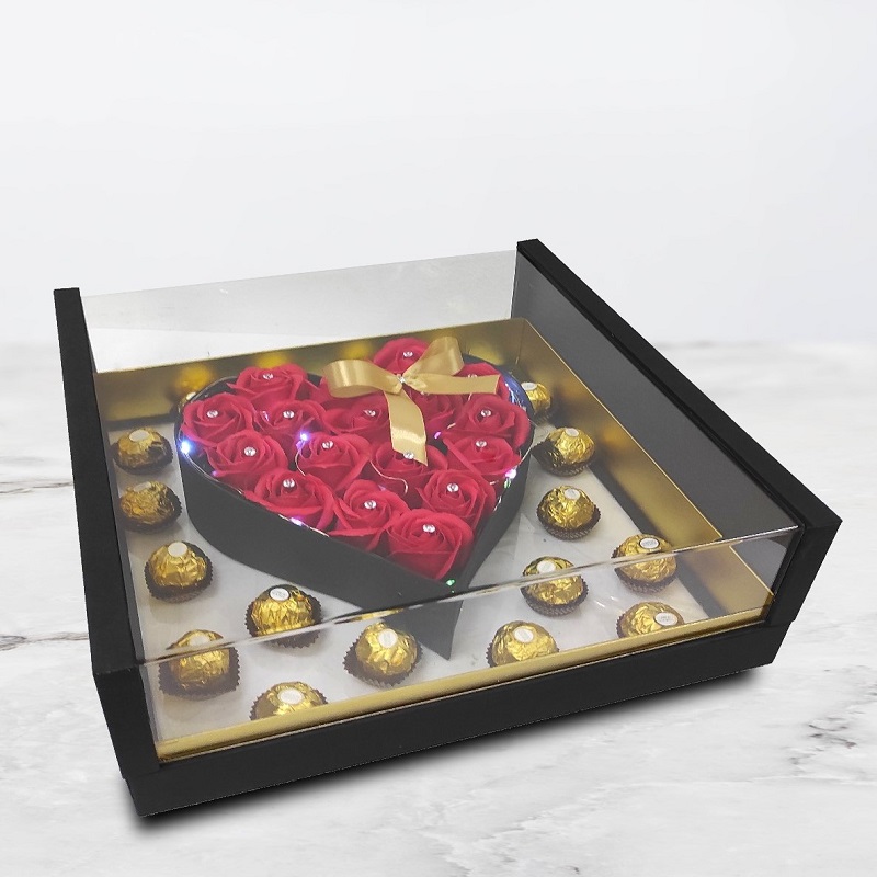 red roses arranged in the heartshape with led surrounded by ferrero rocher
