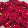 red roses decorated with diamond pin in a box