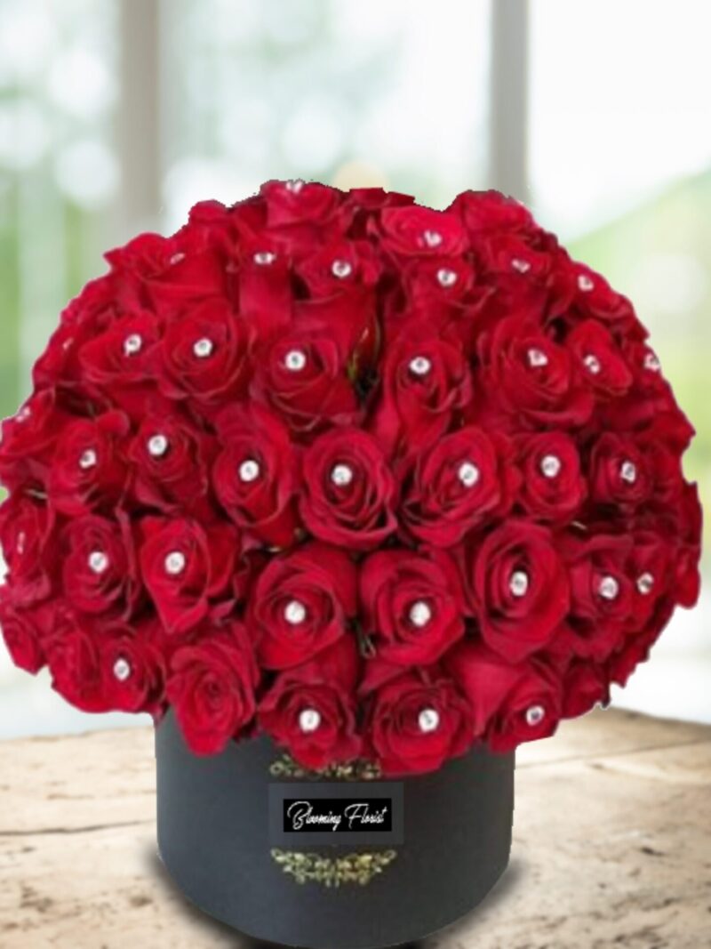 red roses decorated with diamond pin in a box